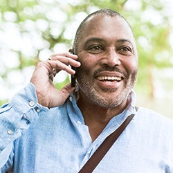 Smiling man on cellphone outdoors