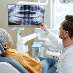 a dentist explaining an X ray to a patient