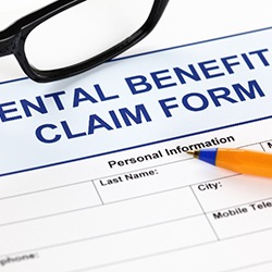 Pen lying on dental benefits claim form