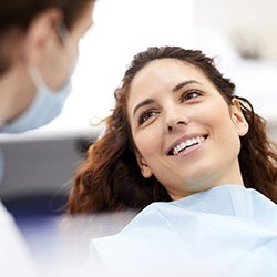 Woman smiling at dentist after root canal therapy in Groveport, OH